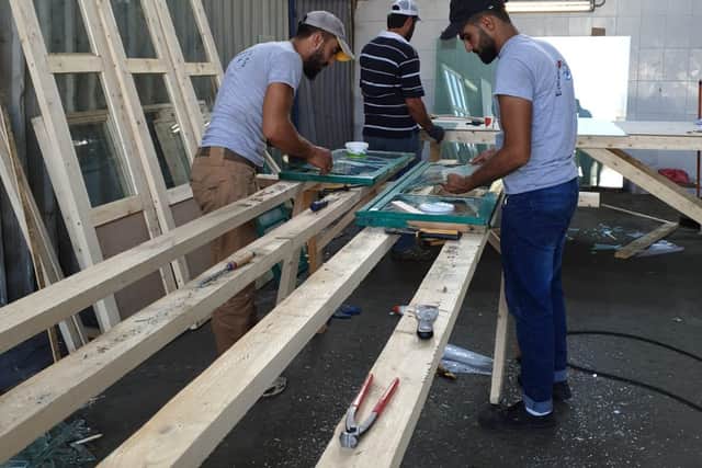 Glass panes are cut to size at Edinburgh Direct Aid's workshop in Beirut.