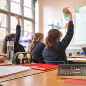 A teacher and students in a classroom. Image: PA