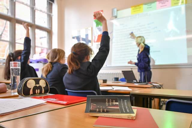 A teacher and students in a classroom. Image: PA