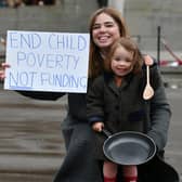 Laura Martin, a member of One Parent Families Scotland, and her daughter Remy protest against cuts to charity funding in Glasgow's George Square (Picture: John Devlin)