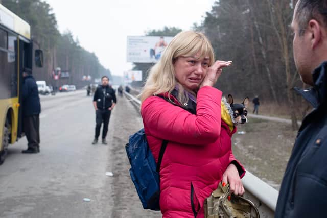 A woman says goodbye to her husband, who is a member of a Ukrainian territorial defence unit, as she leaves Irpin (Picture: Anastasia Vlasova/Getty Images)