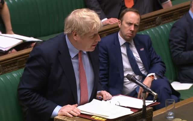 Health Secretary Matt Hancock watches Prime Minister Boris Johnson speak during Prime Minister's Questions in the House of Commons