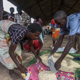 A displaced woman gets her ration of maize at a camp for people displaced by flash floods in Bangula, southern Malawi, in 2019 (Picture: Amos Gumulira/AFP via Getty Images)