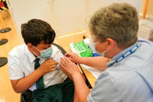 Felix Dima, 13, from Newcastle receives the Pfizer-BioNTech COVID-19 vaccine at the Excelsior Academy on September 22, 2021 in Newcastle upon Tyne, England. Photo by Ian Forsyth/Getty Images