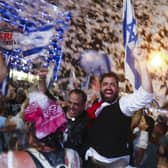 Israelis celebrate the swearing in of the new government in Tel Aviv on Sunday