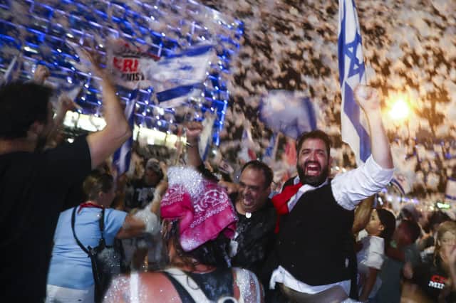 Israelis celebrate the swearing in of the new government in Tel Aviv on Sunday