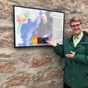Dacre Stoker beside the plaque on the wall of the Kilmarnock Arms Hotel. (Pic: Dacre Stoker)
