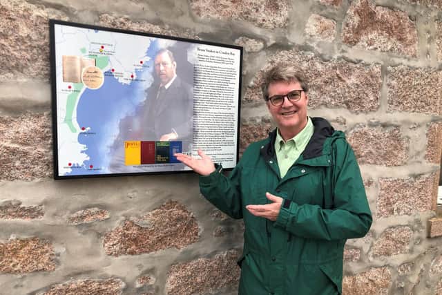 Dacre Stoker beside the plaque on the wall of the Kilmarnock Arms Hotel. (Pic: Dacre Stoker)