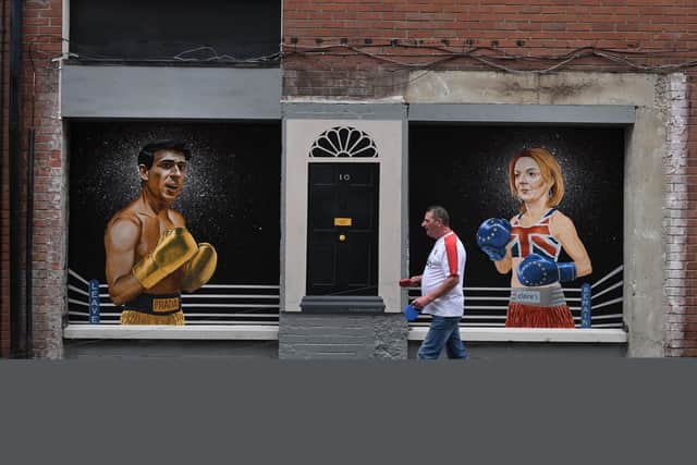 A mural in Belfast depicts Conservative party leadership hopefuls Rishi Sunak and Liz Truss in boxing gear and the door to 10 Downing Street (Picture: Charles McQuillan/Getty Images)