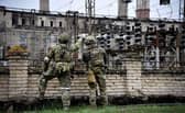 Russian soldiers stand guard at the Luhansk power plant in the town of Shchastya. This picture was taken during a trip organised by the Russian military. (Photo by Alexander NEMENOV / AFP)