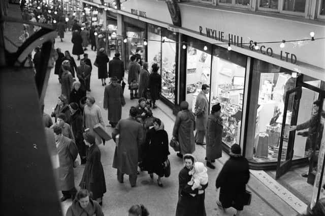 Shoppers go looking for their festive gifts outside of R Wylie Hill and Co Ltd in Glasgow's Argyll Arcade in December 1959.