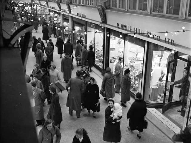 Shoppers go looking for their festive gifts outside of R Wylie Hill and Co Ltd in Glasgow's Argyll Arcade in December 1959.