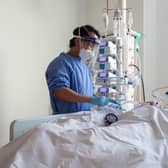 A nurse checks checks on a patient suffering with Covid-19 on the critical care unit. Picture: PA Media