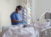 A nurse checks checks on a patient suffering with Covid-19 on the critical care unit. Picture: PA Media