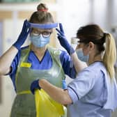 Nurses changing their PPE on Ward 5, a Covid Red Ward, at the Royal Alexandra Hospital in Paisley in January 2021. Picture: PA Media.