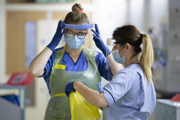 Nurses changing their PPE on Ward 5, a Covid Red Ward, at the Royal Alexandra Hospital in Paisley in January 2021. Picture: PA Media.