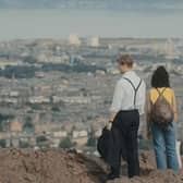Ambika Mod and Leo Woodall as Emma and Dexter on Arthur's Seat, in the Netflis adaptation of David Nicholl's bestselling novel, One Day. Pic: Netflix