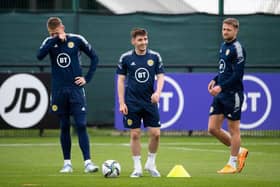 Billy Gilmour (centre) in upbeat mood during a Scotland training session on Sunday with Scott McTominay (left) and Liam Cooper (right). (Photo by Paul Devlin / SNS Group)
