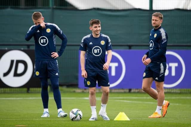Billy Gilmour (centre) in upbeat mood during a Scotland training session on Sunday with Scott McTominay (left) and Liam Cooper (right). (Photo by Paul Devlin / SNS Group)