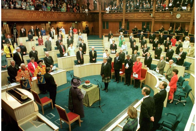 Her Majesty The Queen accompanied by the Royal Party look on as the 15th Duke of Hamilton presents the Crown of Scotland to the Chamber during the Opening of The Scottish Parliament in Edinburgh on 1 July 1999.