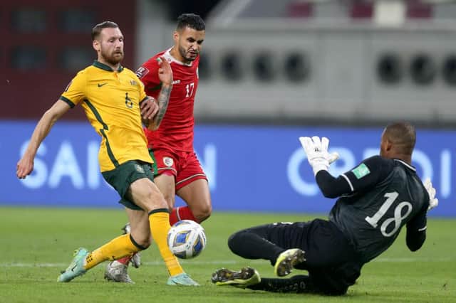 Martin Boyle of Australia and Faiz al-Rushaidi goalkeeper of Oman and Ali al-Busaidi of Oman battle for the ball during the 2022 FIFA World Cup Qualifier match between Australia and Oman at Khalifa International Stadium on October 7, 2021 in Doha, Qatar. (Photo by Mohamed Farag/Getty Images)