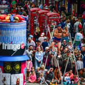 Edinburgh Festival Fringe entertainers perform on the Royal Mile in 2019. (Photo by Jeff J Mitchell/Getty Images)