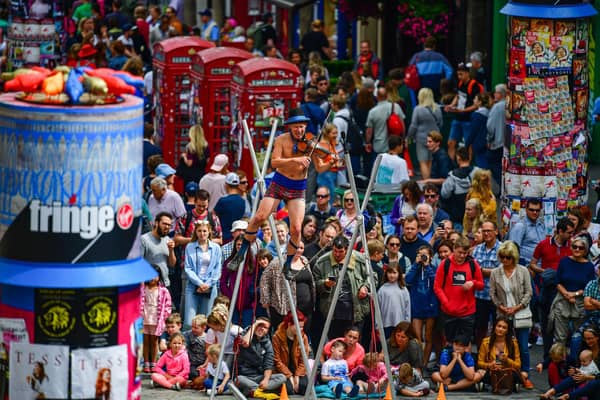 Edinburgh Festival Fringe entertainers perform on the Royal Mile in 2019. (Photo by Jeff J Mitchell/Getty Images)