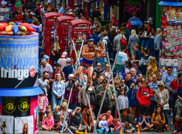 Edinburgh Festival Fringe entertainers perform on the Royal Mile in 2019. (Photo by Jeff J Mitchell/Getty Images)