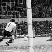 Kenny Dalglish slides in the winning goal through keeper Ray Clemence's legs for Scotland against England at Hampden in May 1976. Picture: Allan Milligan