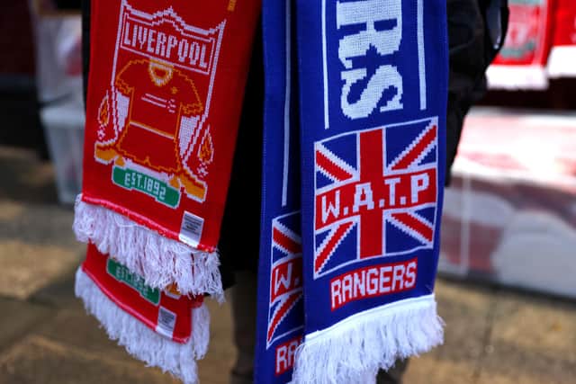 A Liverpool and Rangers scarf is seen outside the stadium.