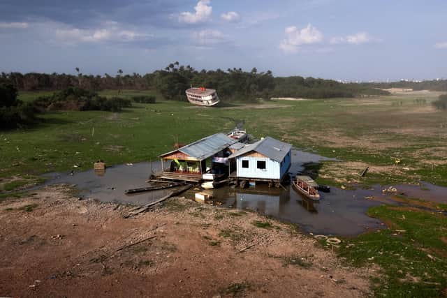 House that once floated in Cacau Pirêra harbour, Brazil, lie grounded during a severe drought in October (Picture: Bruno Zanardo/Getty Images)