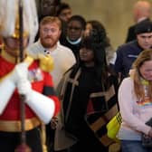 Members of the public pay their respects as they pass the coffin of Queen Elizabeth II inside Westminster Hall (Photo by MARKUS SCHREIBER/POOL/AFP via Getty Images)