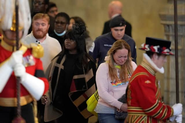 Members of the public pay their respects as they pass the coffin of Queen Elizabeth II inside Westminster Hall (Photo by MARKUS SCHREIBER/POOL/AFP via Getty Images)