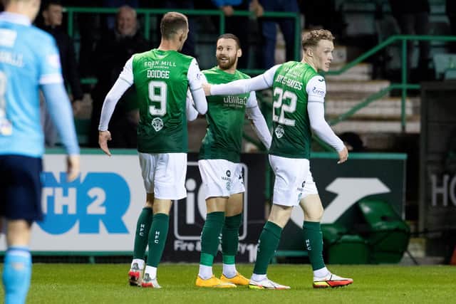 Hibs forward Martin Boyle (centre) celebrates after his cross was turned into his own net by Dundee's Paul McMullan. (Photo by Ross Parker / SNS Group)