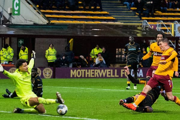 Motherwell's Blair Spittal (R) scores to make it 1-0 against Livingston.
