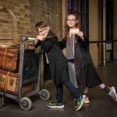 Molly (9) and Tom (7) pose with the Harry Potter Platform 9 ¾ trolley at King’s Cross Station, as it is announced that a replica trolley will soon be stopping at Edinburgh Waverley.