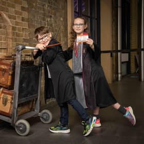 Molly (9) and Tom (7) pose with the Harry Potter Platform 9 ¾ trolley at King’s Cross Station, as it is announced that a replica trolley will soon be stopping at Edinburgh Waverley.
