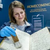 Conservator Suzanne Reid inspecting the Robert Burns First Commonplace book which, along with 12 manuscripts,  represent a "treasure trove" of the Bard's works which have been saved for the nation.