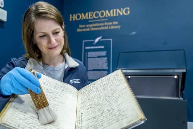 Conservator Suzanne Reid inspecting the Robert Burns First Commonplace book which, along with 12 manuscripts,  represent a "treasure trove" of the Bard's works which have been saved for the nation.