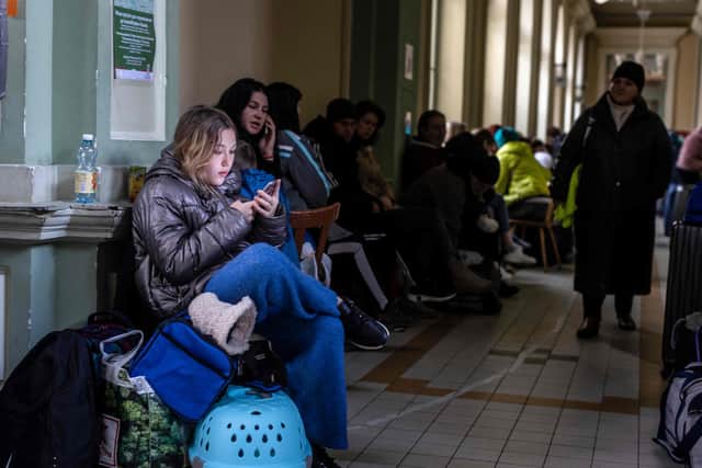 Refugees from Ukraine are seen waiting at the railway station in Przemysl, southeastern Poland, on Sunday