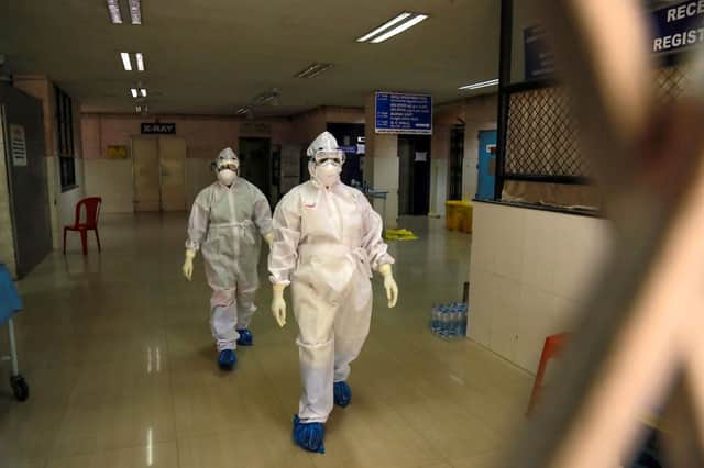 Health officials in full protective gear walk inside an isolation ward at Ernakulam Medical College in Kochi, India, after a 23-year-old student was infected by the potentially deadly Nipah virus (Picture: STR/AFP via Getty Images)