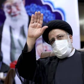 Ebrahim Raisi, head of Iran's judiciary, waves to journalists while registering his candidacy for the upcoming presidential elections at the Interior Ministry in Tehran (Picture: Ebrahim Noroozi/AP)