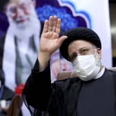 Ebrahim Raisi, head of Iran's judiciary, waves to journalists while registering his candidacy for the upcoming presidential elections at the Interior Ministry in Tehran (Picture: Ebrahim Noroozi/AP)