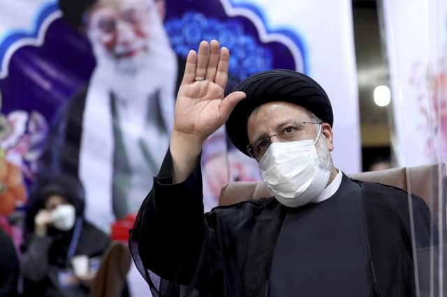 Ebrahim Raisi, head of Iran's judiciary, waves to journalists while registering his candidacy for the upcoming presidential elections at the Interior Ministry in Tehran (Picture: Ebrahim Noroozi/AP)