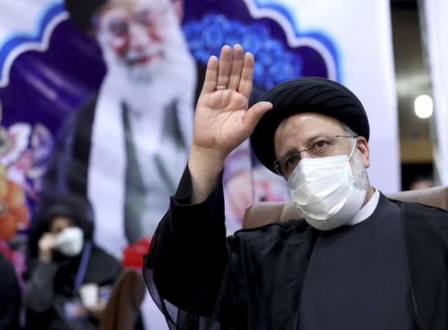 Ebrahim Raisi, head of Iran's judiciary, waves to journalists while registering his candidacy for the upcoming presidential elections at the Interior Ministry in Tehran (Picture: Ebrahim Noroozi/AP)