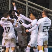 Livingston's Ayo Obileye celebrates with team-mates after making it 1-0 against Dundee United.