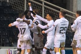 Livingston's Ayo Obileye celebrates with team-mates after making it 1-0 against Dundee United.