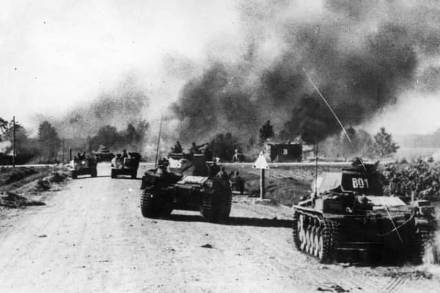 July 1941: Panzer units of the German Army pass through a blazing Russian village, torched by the evacuees, during Operation Barbarossa PIC: Keystone/Getty Images