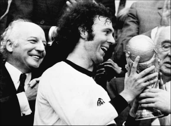 Franz Beckenbauer receives the World Cup after victory over Holland in the 1974 final at Munich's Olympic stadium. (Photo by STF/AFP via Getty Images)