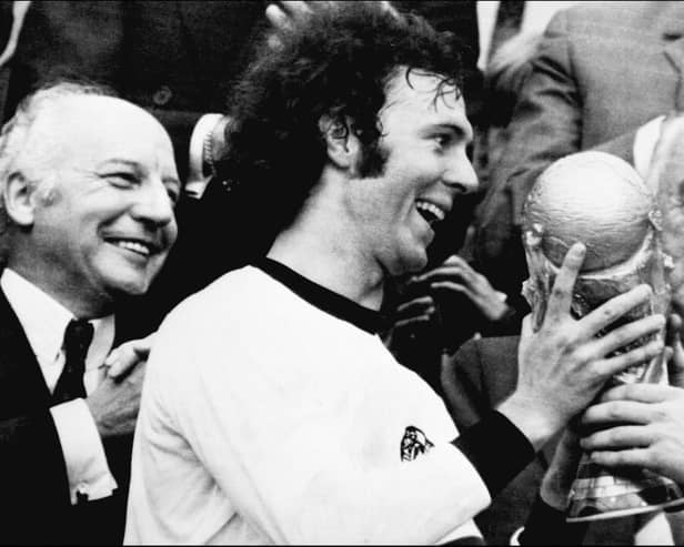 Franz Beckenbauer receives the World Cup after victory over Holland in the 1974 final at Munich's Olympic stadium. (Photo by STF/AFP via Getty Images)